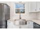 Modern farmhouse sink in a kitchen with white cabinets and granite countertops at 1244 Bob Falls Rd, Shelby, NC 28150