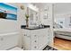 Guest bathroom with white vanity, dark countertop, and nautical decor at 191 Oak Village Pkwy, Mooresville, NC 28117