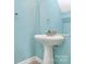 Small bathroom with pedestal sink and light blue walls at 2030 Cambridge Beltway Dr, Charlotte, NC 28273