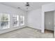 Bright bedroom featuring three windows and carpet flooring at 2030 Cambridge Beltway Dr, Charlotte, NC 28273