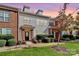 Brick front end unit townhome with landscaping and a blue door at 2030 Cambridge Beltway Dr, Charlotte, NC 28273