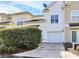 Townhouse exterior featuring a private driveway, attached garage, and neatly landscaped area at 2030 Cambridge Beltway Dr, Charlotte, NC 28273