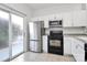 Modern kitchen with stainless steel appliances and white cabinets at 2030 Cambridge Beltway Dr, Charlotte, NC 28273