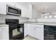 Modern kitchen with stainless steel appliances and white cabinets at 2030 Cambridge Beltway Dr, Charlotte, NC 28273