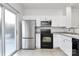 Modern kitchen with stainless steel appliances and white cabinets at 2030 Cambridge Beltway Dr, Charlotte, NC 28273