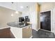 Modern kitchen with curved island and black appliances at 2125 Southend Dr # 349, Charlotte, NC 28203