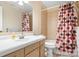 Cozy bathroom featuring a shower-tub combo with patterned curtain, vanity and mirror at 2401 Boy Scout Rd, Lincolnton, NC 28092