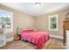 Bedroom with guitar, laminate floors, and two windows offering plentiful natural light at 2401 Boy Scout Rd, Lincolnton, NC 28092