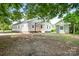 Charming single-story home with white siding, surrounded by mature trees on a spacious lot at 2401 Boy Scout Rd, Lincolnton, NC 28092