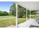 A covered front porch offers a serene spot to enjoy the view of the yard and nearby road at 2401 Boy Scout Rd, Lincolnton, NC 28092