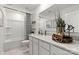 Modern bathroom with a clean design, featuring white cabinets, a large mirror, and stylish fixtures at 2561 Blue Sky Meadows Dr, Monroe, NC 28110