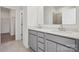 Bathroom featuring a double sink vanity, a large mirror and neutral tile at 2561 Blue Sky Meadows Dr, Monroe, NC 28110