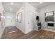 Welcoming entryway featuring coat rack, bench, artwork and adjacent laundry room with modern appliances at 2561 Blue Sky Meadows Dr, Monroe, NC 28110