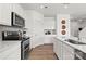 Modern kitchen featuring sleek appliances, white cabinets, and a convenient sink at 2561 Blue Sky Meadows Dr, Monroe, NC 28110