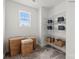 Organized laundry room with shelving, baskets, and a bright window, offering both functionality and natural light at 2561 Blue Sky Meadows Dr, Monroe, NC 28110