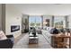 Spacious living room featuring hardwood floors, a modern fireplace, and large windows with natural light at 2561 Blue Sky Meadows Dr, Monroe, NC 28110