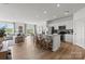 Open living space with a view into dining area and a stylish island with barstool seating at 2561 Blue Sky Meadows Dr, Monroe, NC 28110