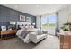 Comfortable main bedroom with accent wall, large windows, and plush carpeting at 2561 Blue Sky Meadows Dr, Monroe, NC 28110