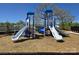 Community playground with multiple slides, climbing structures, and a soft landing surface at 2565 Blue Sky Meadows Dr, Monroe, NC 28110