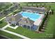 Rendering of community pool featuring lounge chairs, shaded tables, and a clubhouse at 2565 Blue Sky Meadows Dr, Monroe, NC 28110