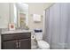 Well-lit bathroom featuring a granite countertop vanity, toilet, and a shower with a curtain at 3029 Quinebaug Rd, Fort Mill, SC 29715