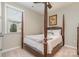 Comfortable bedroom featuring a four-poster bed, neutral walls, and a window, creating a tranquil retreat at 3029 Quinebaug Rd, Fort Mill, SC 29715