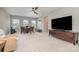 Spacious living area features a ceiling fan, large windows, and modern entertainment center at 3029 Quinebaug Rd, Fort Mill, SC 29715