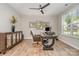 Well-lit office with a large desk, wooden floors, and a ceiling fan, perfect for a productive workspace at 3029 Quinebaug Rd, Fort Mill, SC 29715