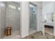 Modern bathroom featuring a glass-enclosed shower and a separate tiled shower with a wooden bench at 3029 Quinebaug Rd, Fort Mill, SC 29715