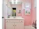 Pink bathroom with white vanity, a mirror, and cactus decor at 4815 Sugar And Wine Rd, Monroe, NC 28110