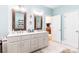 Bathroom with double vanity, a walk-in shower, and light blue walls at 4815 Sugar And Wine Rd, Monroe, NC 28110