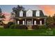 Brick house with a dormer, porch, and landscaping at 4815 Sugar And Wine Rd, Monroe, NC 28110