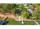 Aerial view of a waterfront property with a private boat launch, dock, and lush greenery at 9542 Riviera Dr, Sherrills Ford, NC 28673