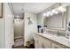 Stylish bathroom featuring granite countertops, white cabinets, and modern fixtures, adjacent to shower and closet space at 9542 Riviera Dr, Sherrills Ford, NC 28673