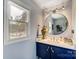 Modern bathroom vanity with a round mirror and stylish fixtures at 9542 Riviera Dr, Sherrills Ford, NC 28673