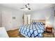 Bright bedroom with a diamond-patterned bedspread and wood flooring at 9542 Riviera Dr, Sherrills Ford, NC 28673