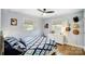 Bright bedroom with a diamond-patterned bedspread, wood flooring, and two windows at 9542 Riviera Dr, Sherrills Ford, NC 28673