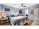 Tranquil bedroom with a window, ceiling fan, and a door to the bathroom at 9542 Riviera Dr, Sherrills Ford, NC 28673