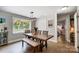 Inviting dining room featuring a large window, stylish light fixture, and easy access to other living spaces at 9542 Riviera Dr, Sherrills Ford, NC 28673