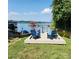 Picturesque lakefront property with colorful chairs on a dock, perfect for relaxation and enjoyment at 9542 Riviera Dr, Sherrills Ford, NC 28673