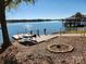 Lakefront views with a pier, picnic table, and firepit for outdoor enjoyment and entertaining at 9542 Riviera Dr, Sherrills Ford, NC 28673