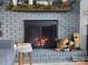 Close-up of a gray brick fireplace with a wood mantel and decor at 9542 Riviera Dr, Sherrills Ford, NC 28673