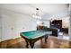 Spacious game room with pool table, perfect for entertaining, adjacent to living area with fireplace and stylish decor at 9542 Riviera Dr, Sherrills Ford, NC 28673