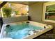 Inviting hot tub in an enclosed patio offers a relaxing retreat with view at 9542 Riviera Dr, Sherrills Ford, NC 28673