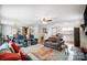 Open-concept living room featuring hardwood floors, a ceiling fan, a sofa, and a view of the kitchen and dining area at 9542 Riviera Dr, Sherrills Ford, NC 28673