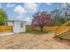 Fenced backyard with storage shed and a colorful tree at 119 Nat Barber Ave, Gastonia, NC 28052