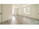 Spacious bedroom with large windows and light grey vinyl flooring at 119 Nat Barber Ave, Gastonia, NC 28052