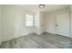 Simple bedroom with a single window and light grey vinyl flooring at 119 Nat Barber Ave, Gastonia, NC 28052