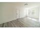 Well lit bedroom with wood-look floors and large windows at 119 Nat Barber Ave, Gastonia, NC 28052