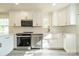 Modern kitchen featuring white shaker cabinets, stainless steel appliances, and quartz countertops at 119 Nat Barber Ave, Gastonia, NC 28052